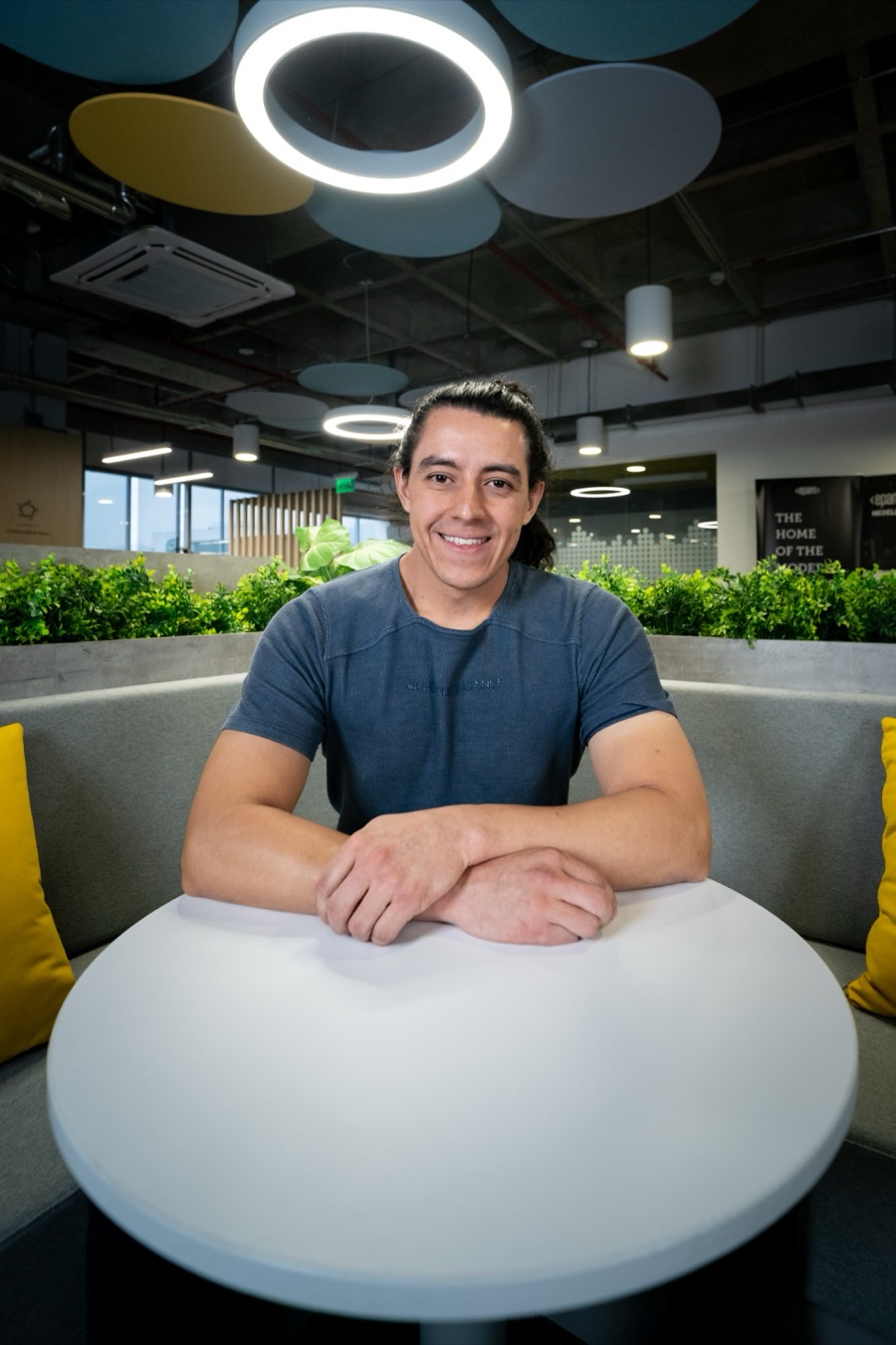 Eimer Castro smiling at a table in the EPAM Medellín office